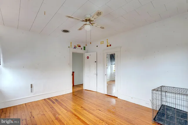 a room with pool table and windows