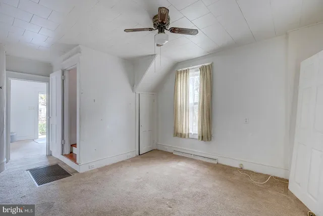 a view of a livingroom with a ceiling fan and window