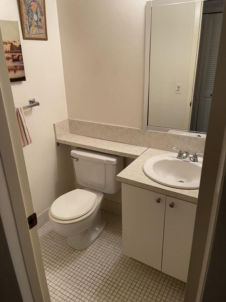152 Suffolk F Boca Raton, FL 33434 - Photo 13 of 26 a bathroom with a sink toilet and mirror