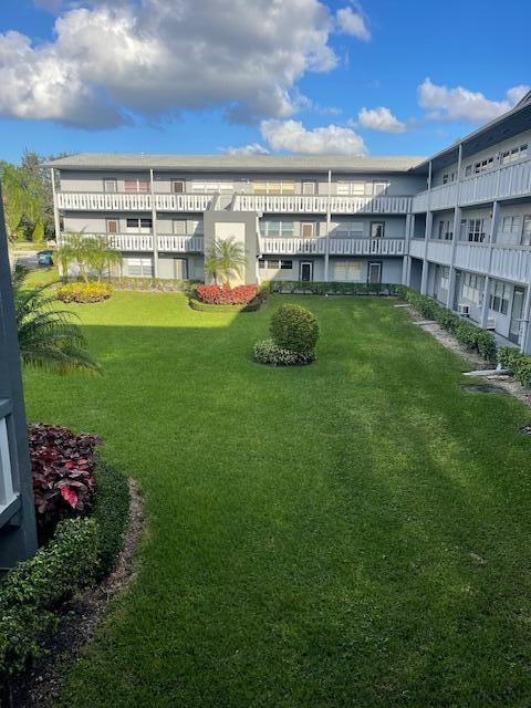 152 Suffolk F Boca Raton, FL 33434 - Photo 19 of 26 a view of a big room with a big yard and large trees