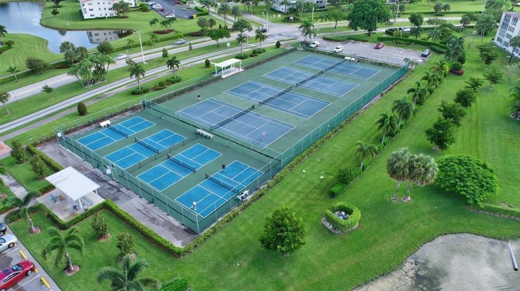 152 Suffolk F Boca Raton, FL 33434 - Photo 25 of 26 a view of a tennis ground with a small yard