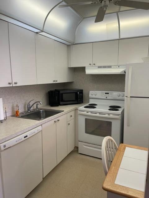 152 Suffolk F Boca Raton, FL 33434 - Photo 4 of 26 a kitchen with stainless steel appliances granite countertop a stove a sink and white cabinets