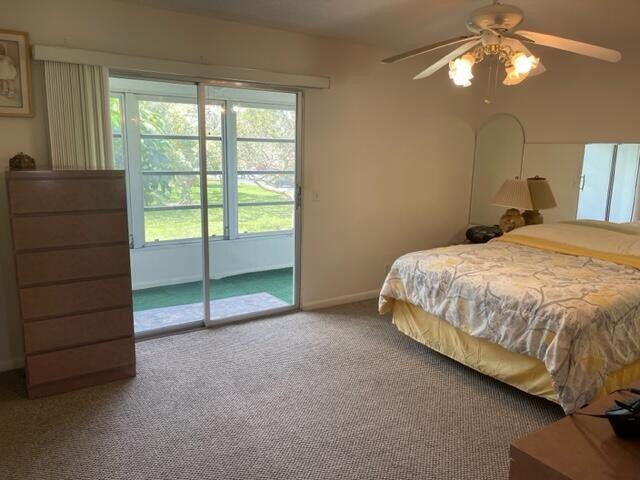 152 Suffolk F Boca Raton, FL 33434 - Photo 9 of 26 a bedroom with a bed and a window