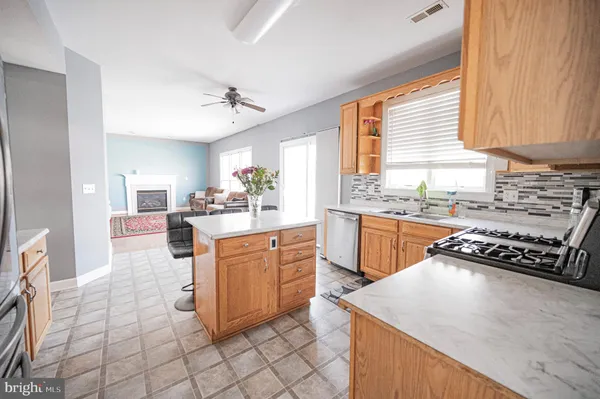 a kitchen with stainless steel appliances granite countertop a sink counter space cabinets and a window