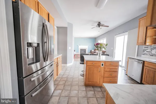 a kitchen with stainless steel appliances a refrigerator sink and microwave
