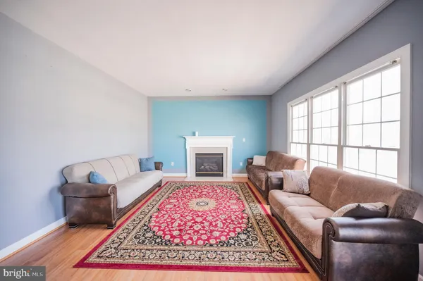 a living room with furniture rug and window