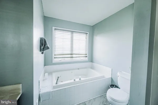 a white bath tub sitting next to a white toilet