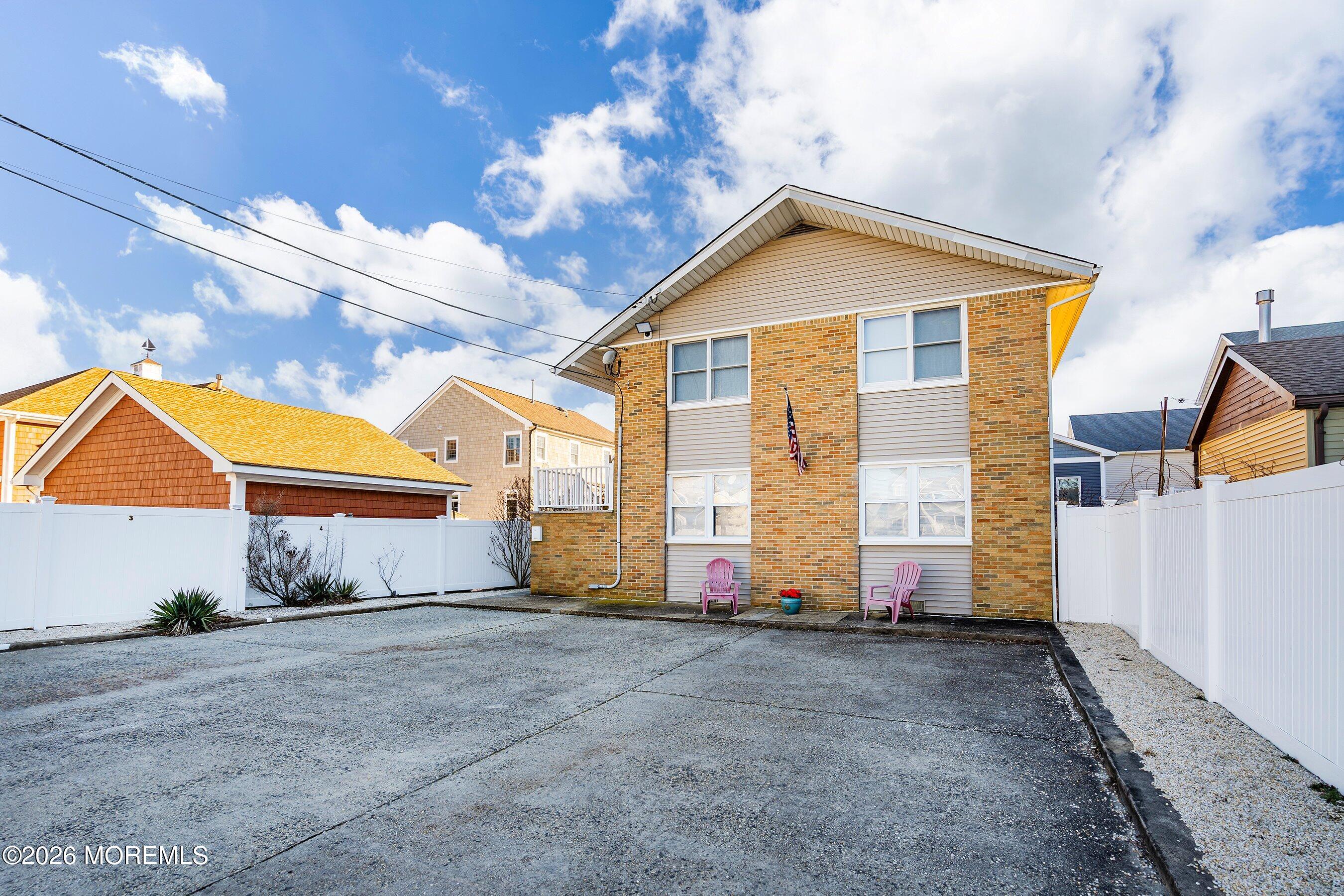 a view of a house with wooden fence