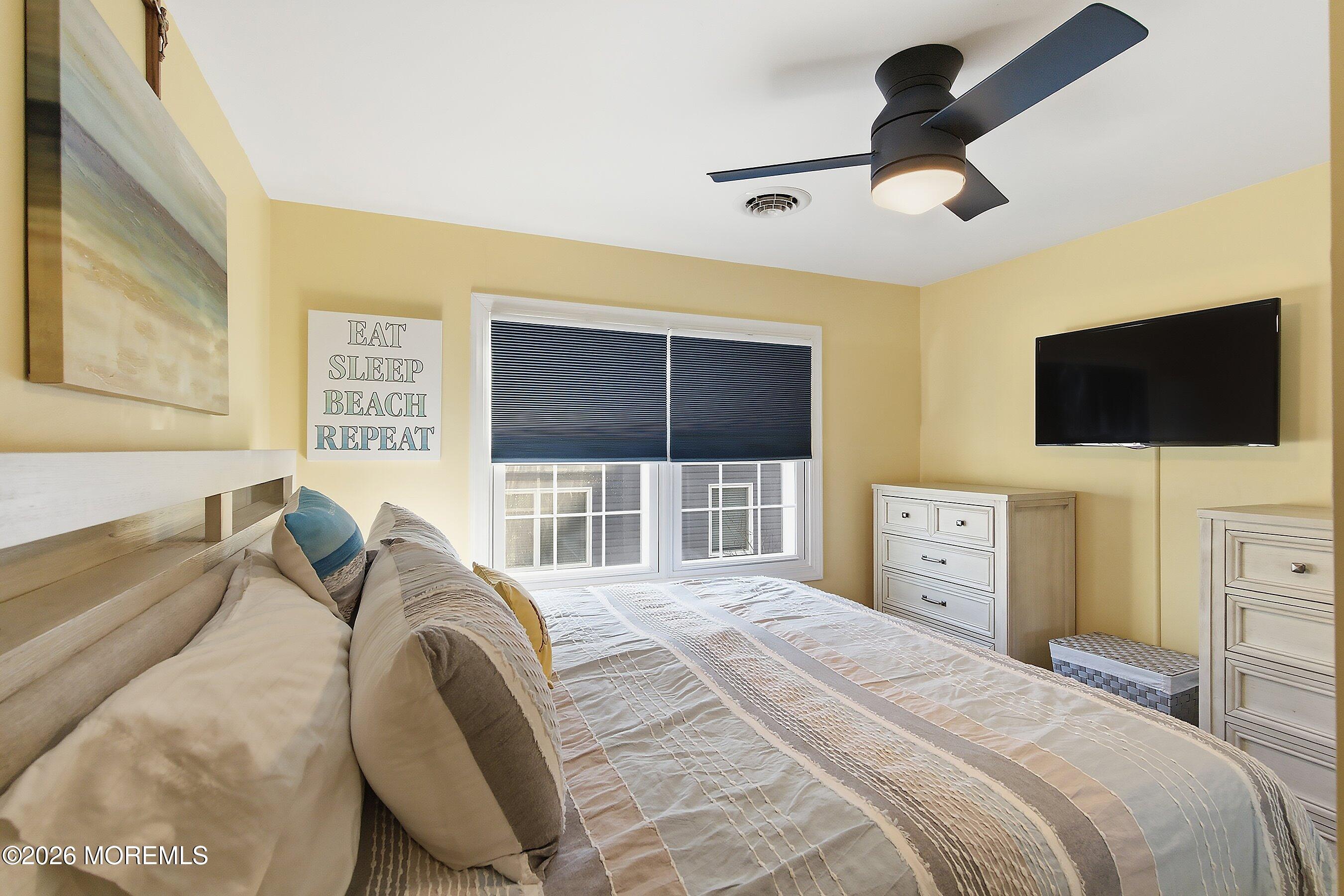 2060 Highway 35, Unit 3 Seaside Heights, NJ 08751 - Photo 14 of 17 a bedroom with a bed and a flat tv screen on the dresser