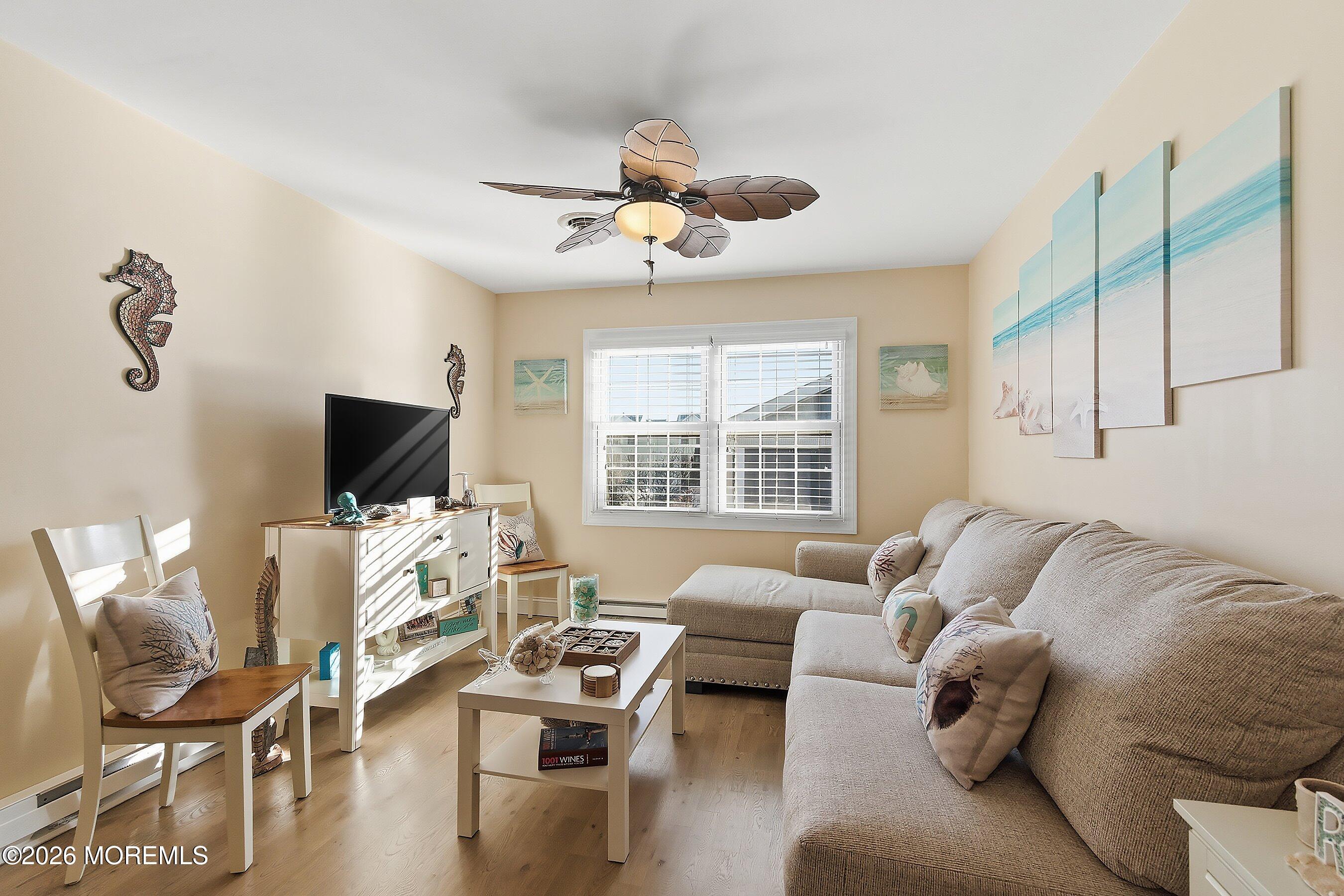2060 Highway 35, Unit 3 Seaside Heights, NJ 08751 - Photo 5 of 17 a living room with furniture a flat screen tv and a large window