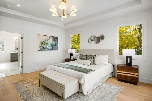 a bedroom with a bed and a chandelier