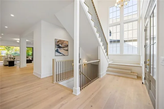 a view of a hallway with wooden floor and windows