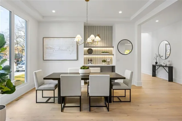 a view of a dining room with furniture and a large window