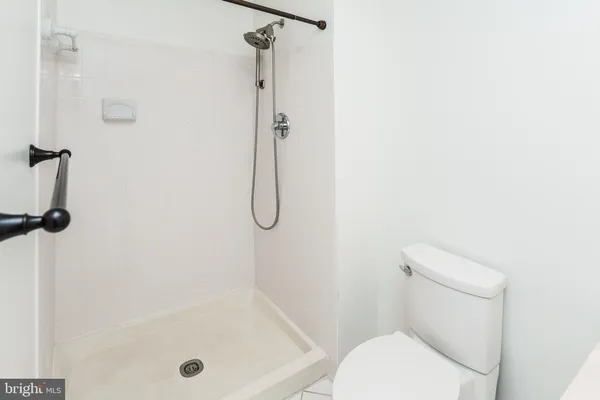 a close view of walk in closet with empty racks