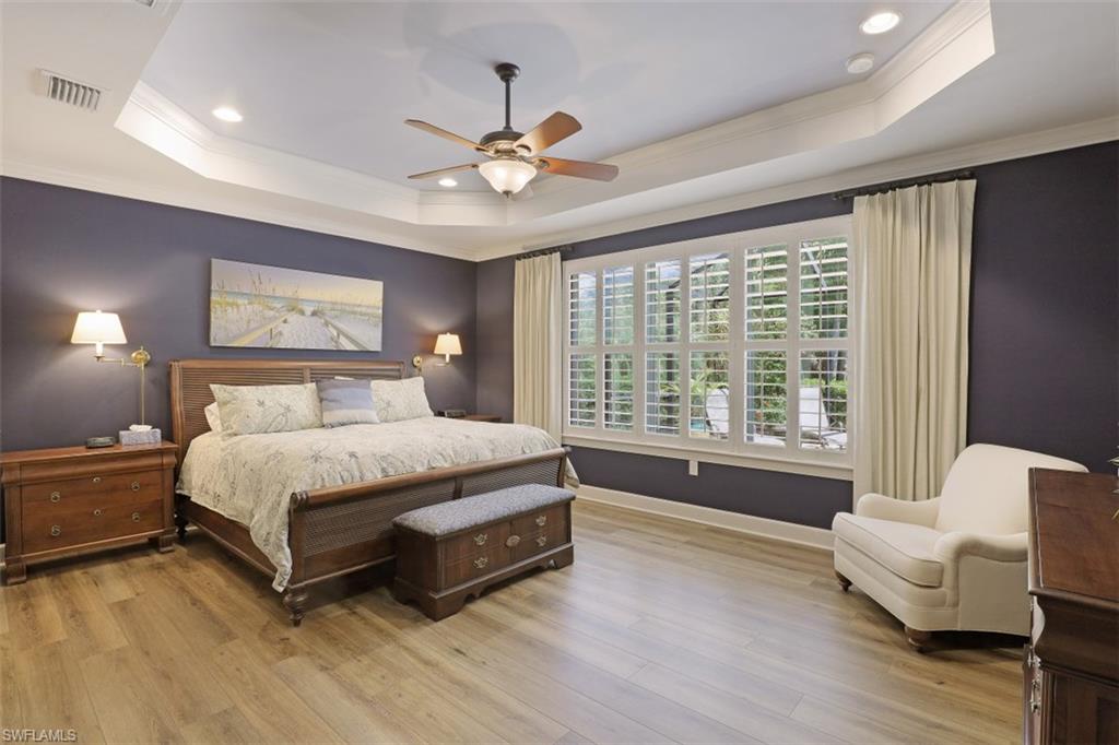 8962 Quarry Drive Naples, FL 34120 - Photo 11 of 35 a spacious bedroom with a bed and a couch