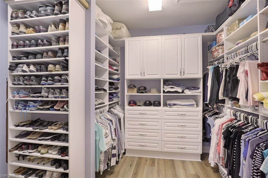 8962 Quarry Drive Naples, FL 34120 - Photo 13 of 35 a view of walk in closet with clothes and shoes
