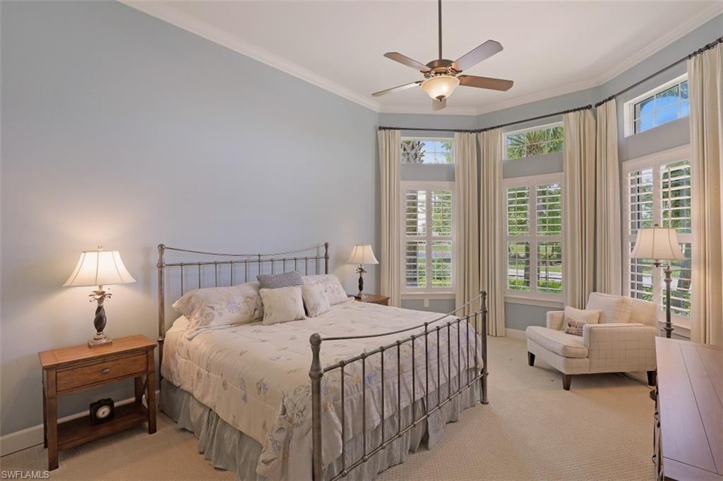 8962 Quarry Drive Naples, FL 34120 - Photo 14 of 35 a bedroom with a bed and a chandelier