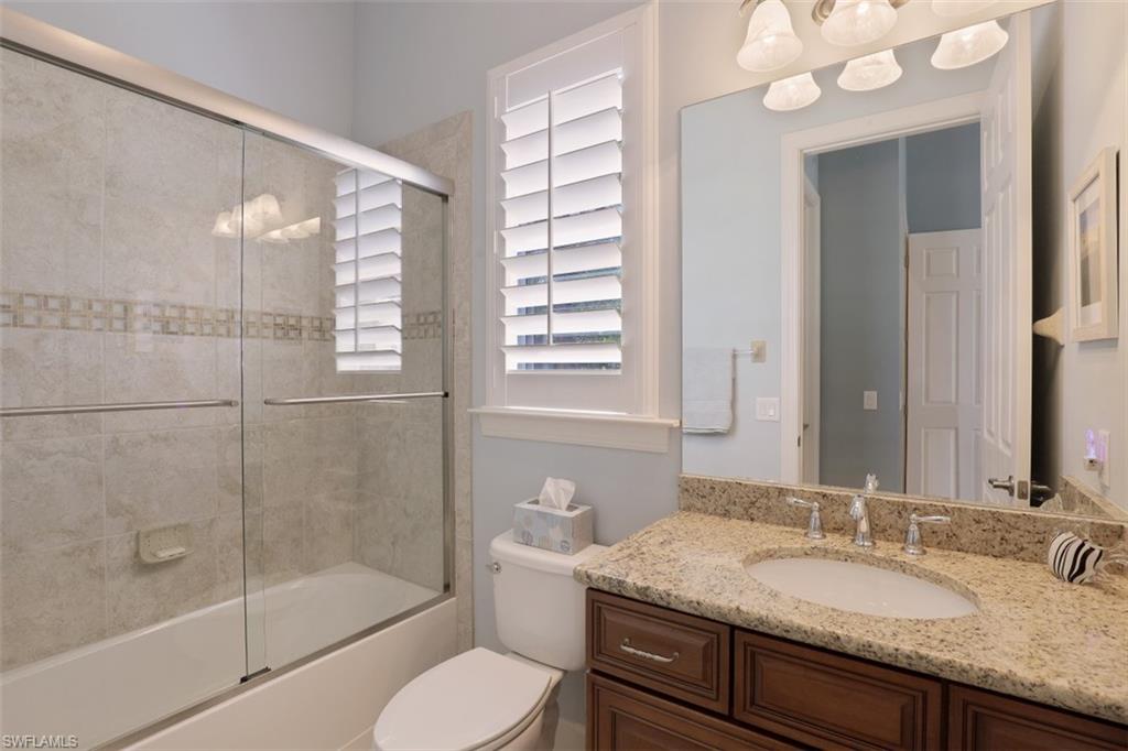 8962 Quarry Drive Naples, FL 34120 - Photo 15 of 35 a bathroom with a granite countertop sink toilet and shower