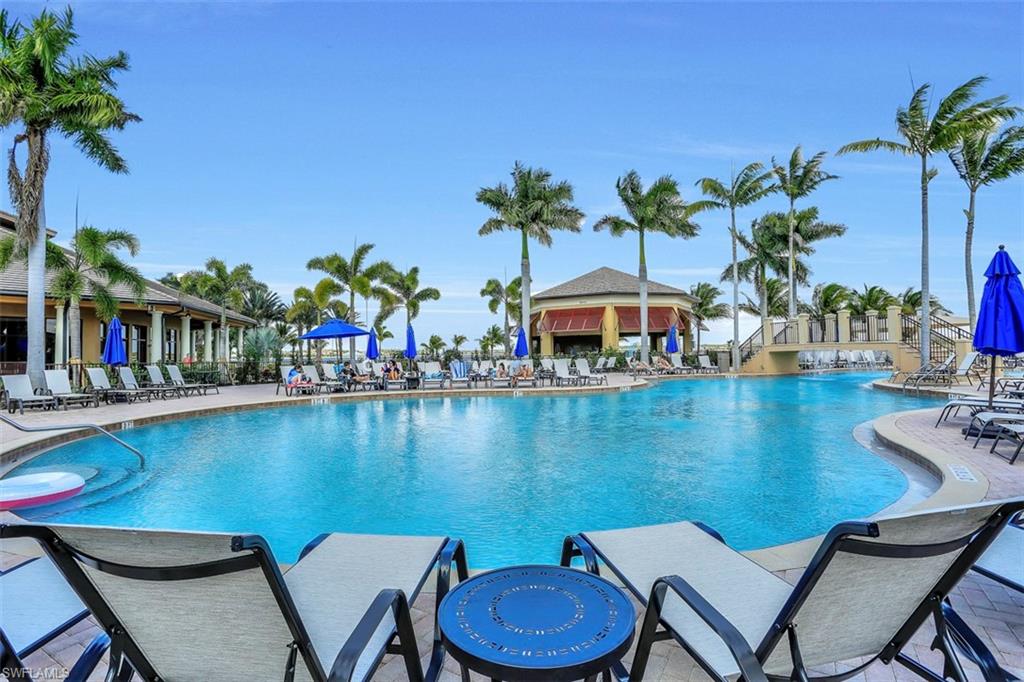 8962 Quarry Drive Naples, FL 34120 - Photo 28 of 35 a view of a swimming pool with a lounge chair