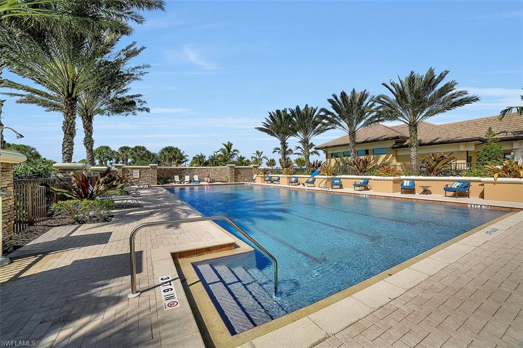 8962 Quarry Drive Naples, FL 34120 - Photo 29 of 35 a view of swimming pool with outdoor seating and plants