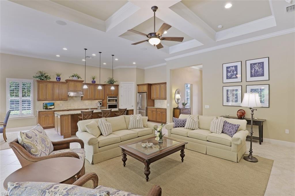 8962 Quarry Drive Naples, FL 34120 - Photo 5 of 35 a living room with furniture kitchen and a chandelier