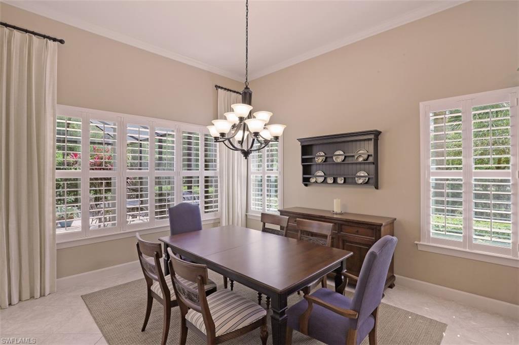 8962 Quarry Drive Naples, FL 34120 - Photo 9 of 35 a view of a dining room with furniture window and outside view