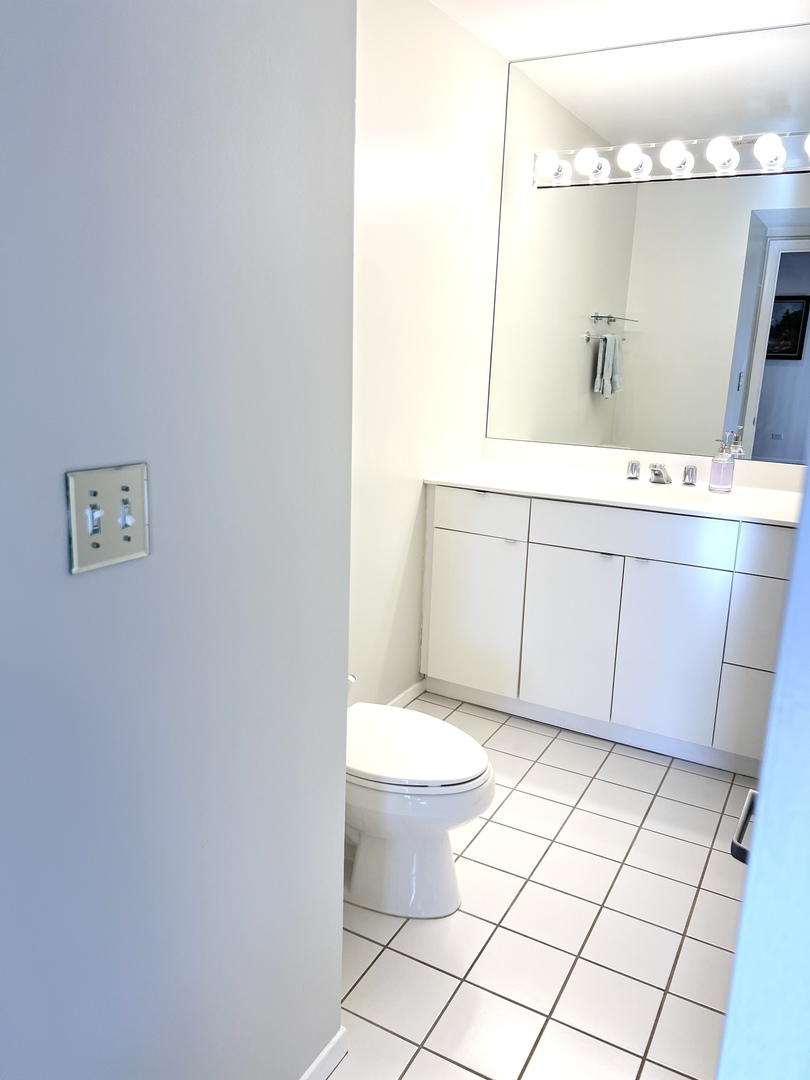 353 Milford Road Deerfield, IL 60015 - Photo 15 of 19 a bathroom with a sink mirror vanity and toilet