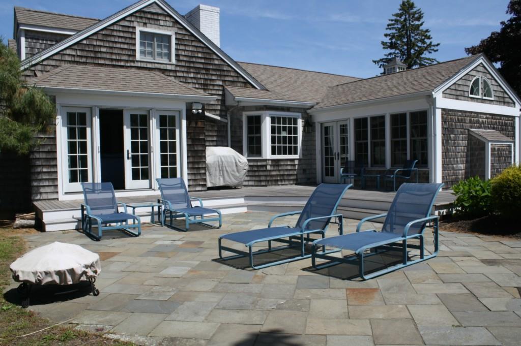 Side view of house showing extensive deck and patio area for enjoying water breezes and water views.