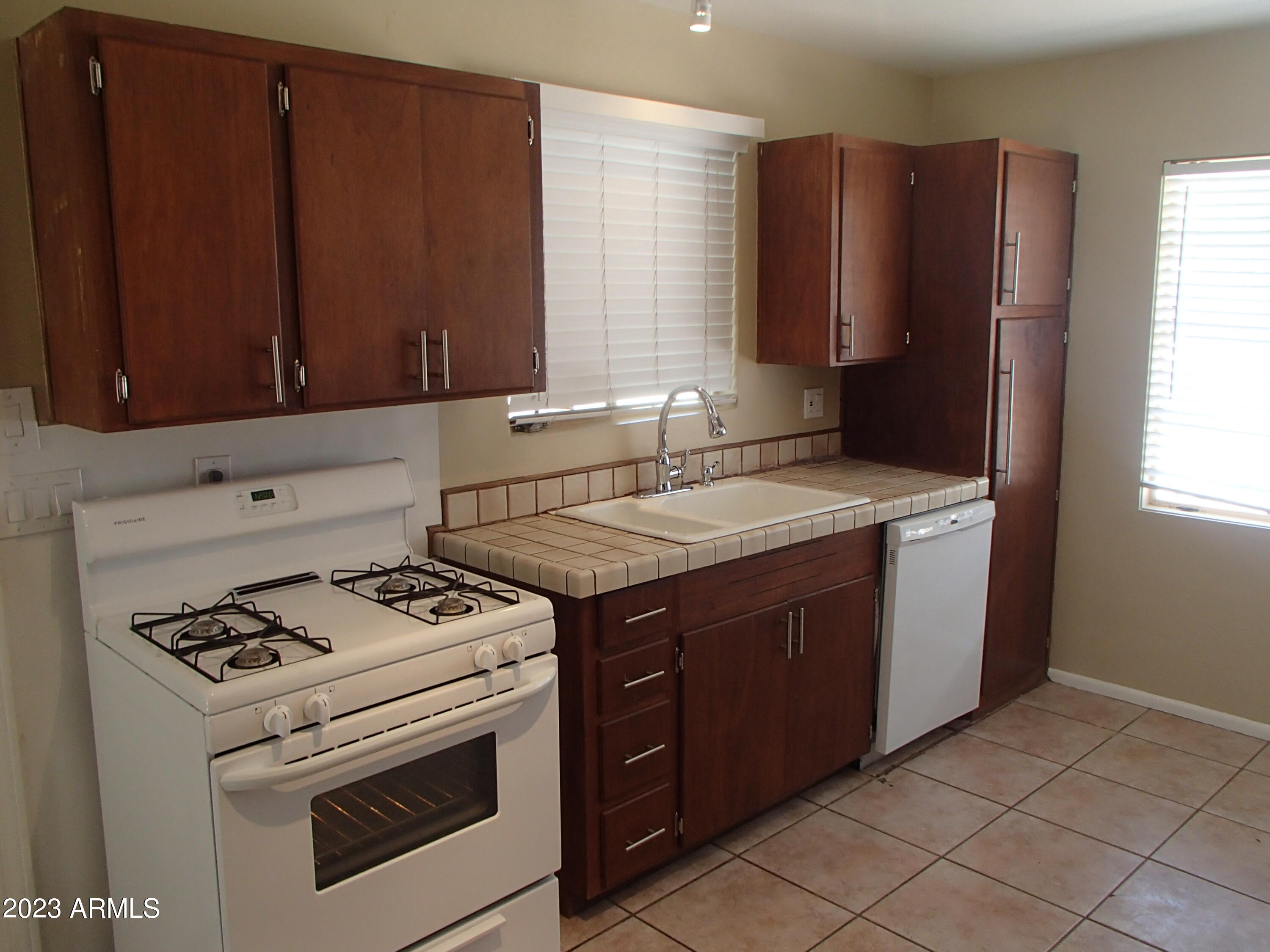 1125 West Colter Street Phoenix, AZ 85013 - Photo 4 of 16 a kitchen with a stove and a microwave