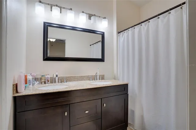 a bathroom with a sink vanity and a mirror