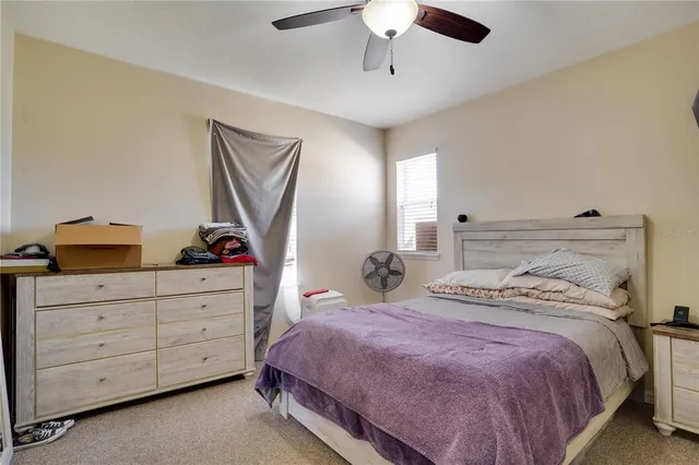 a bedroom with a bed and a dresser