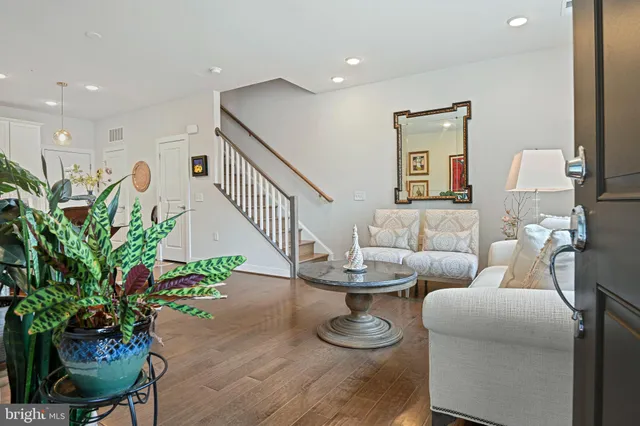 a living room with furniture and a potted plant