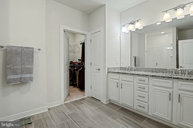 a bathroom with a double vanity sink and a mirror