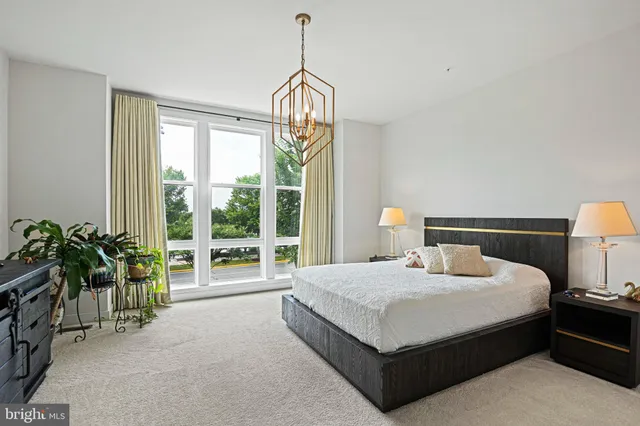 a bedroom with a bed and large window with outer view