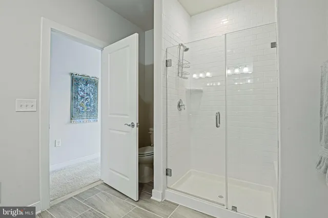 a bathroom with a glass shower door and a shower