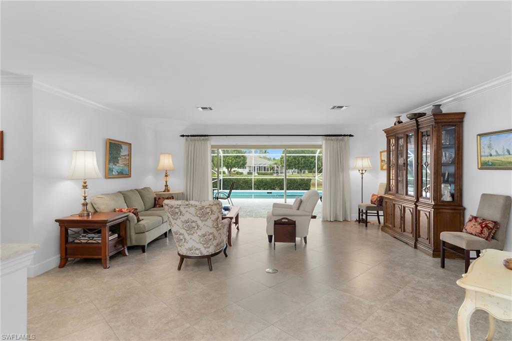 1916 Countess Court Naples, FL 34110 - Photo 16 of 43 a living room with furniture and large windows