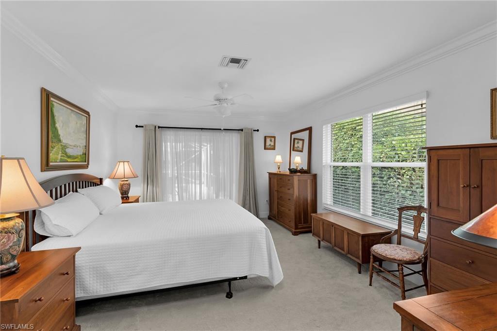 1916 Countess Court Naples, FL 34110 - Photo 22 of 43 a bedroom with a bed and a couch