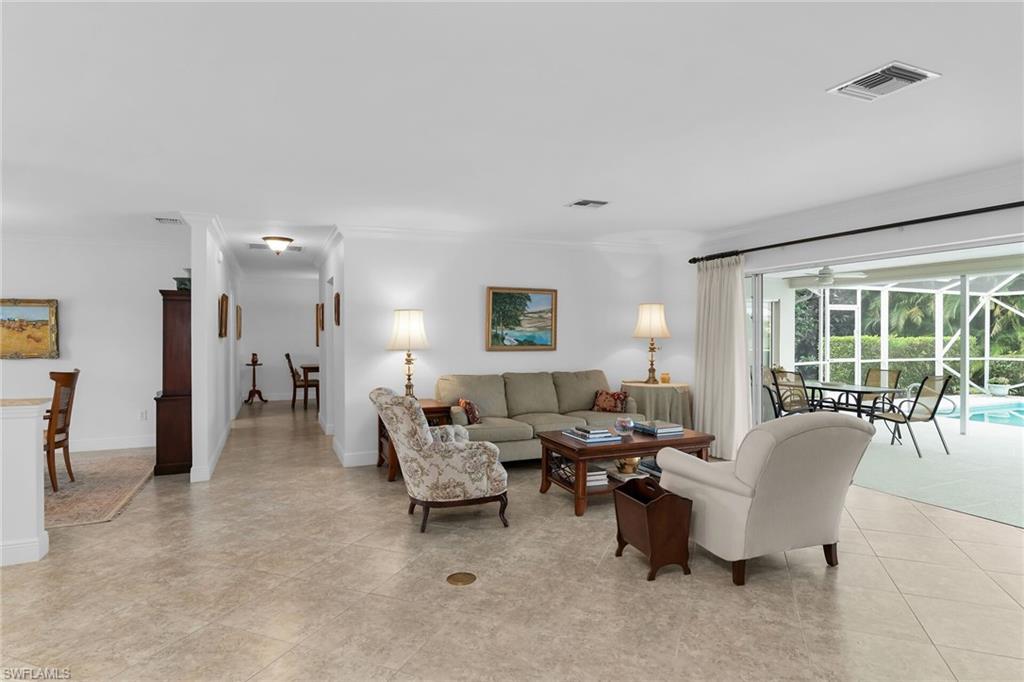 1916 Countess Court Naples, FL 34110 - Photo 23 of 43 a living room with furniture and a large window