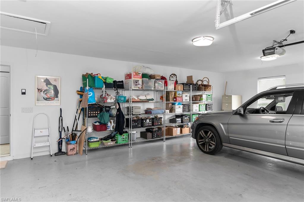 1916 Countess Court Naples, FL 34110 - Photo 29 of 43 a view of a garage with a car and a car