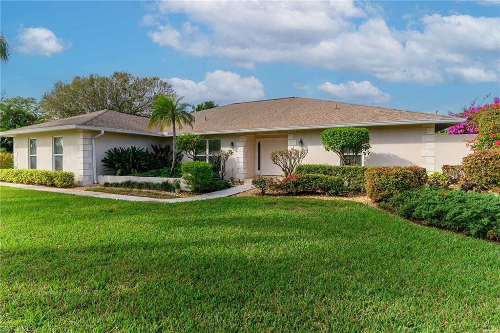 1916 Countess Court Naples, FL 34110 - Photo 3 of 43 a front view of a house with garden