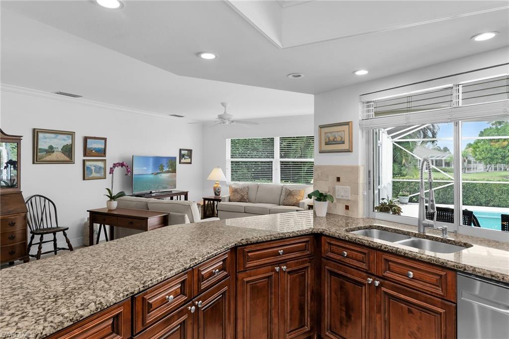1916 Countess Court Naples, FL 34110 - Photo 33 of 43 a kitchen with granite countertop a sink and a counter top space