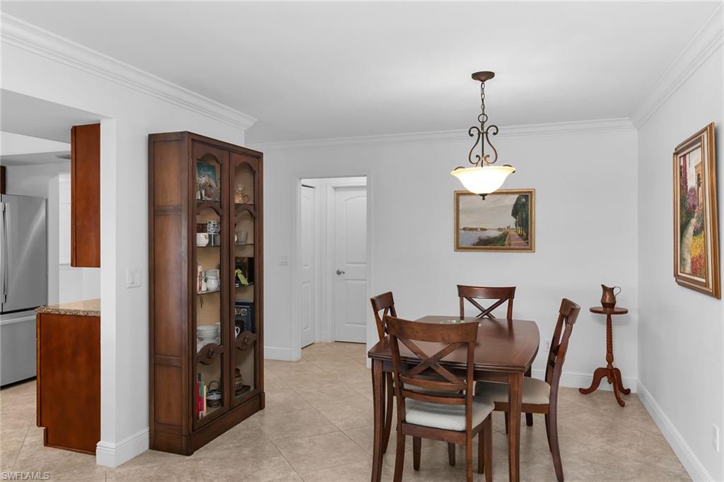 1916 Countess Court Naples, FL 34110 - Photo 37 of 43 a view of a dining room with furniture and chandelier