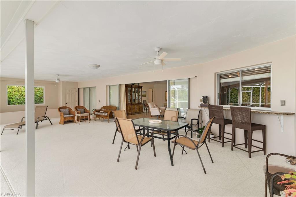 1916 Countess Court Naples, FL 34110 - Photo 43 of 43 a dining room with furniture and a large window