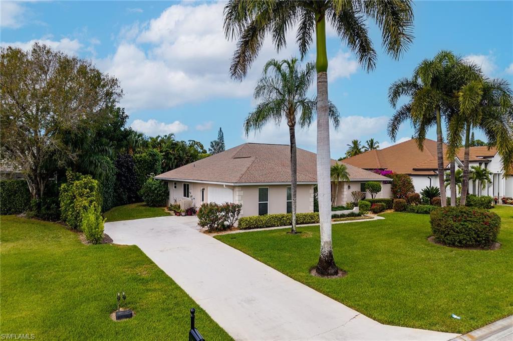 1916 Countess Court Naples, FL 34110 - Photo 6 of 43 a front view of house with yard and green space