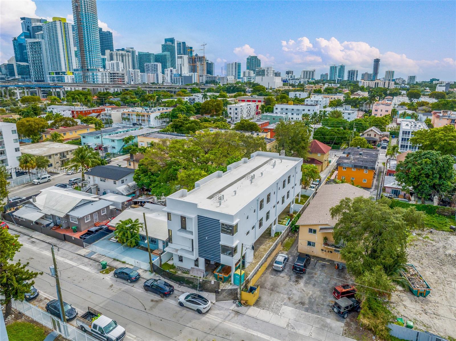 an aerial view of residential houses with outdoor space and street view