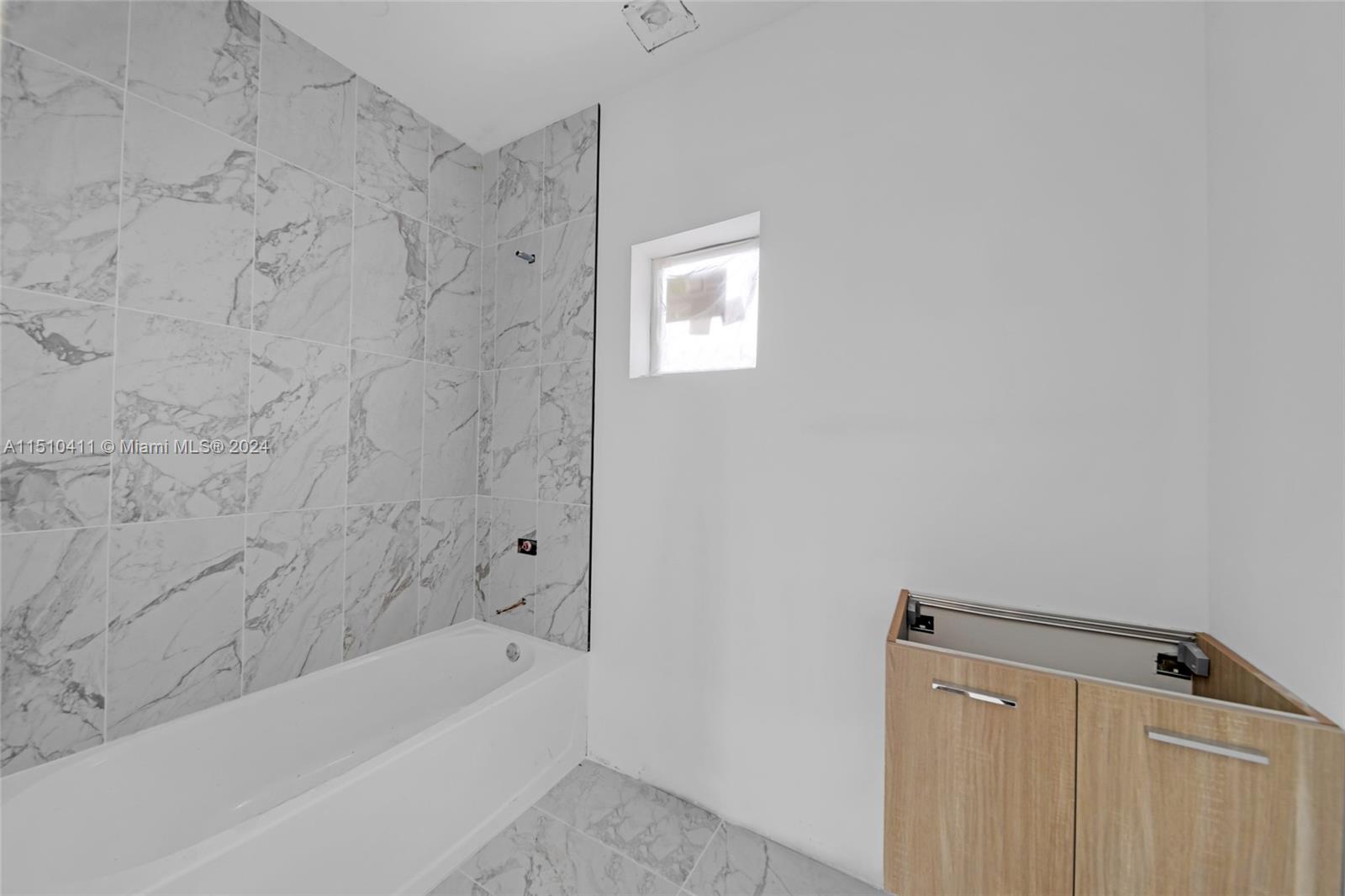 526 Southwest 2nd Street Miami, FL 33130 - Photo 8 of 22 a bathroom with a bathtub and a shower