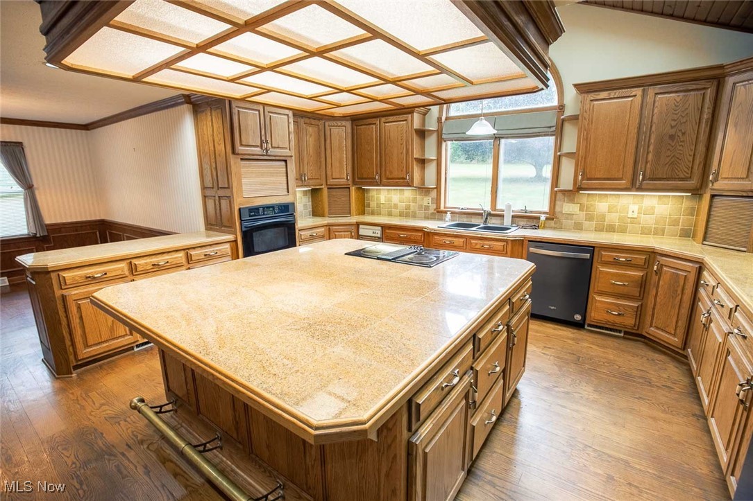9046 River Styx Road Wadsworth, OH 44281 - Photo 2 of 30 Kitchen featuring dark wood-type flooring, dishwasher, black oven, and a kitchen island