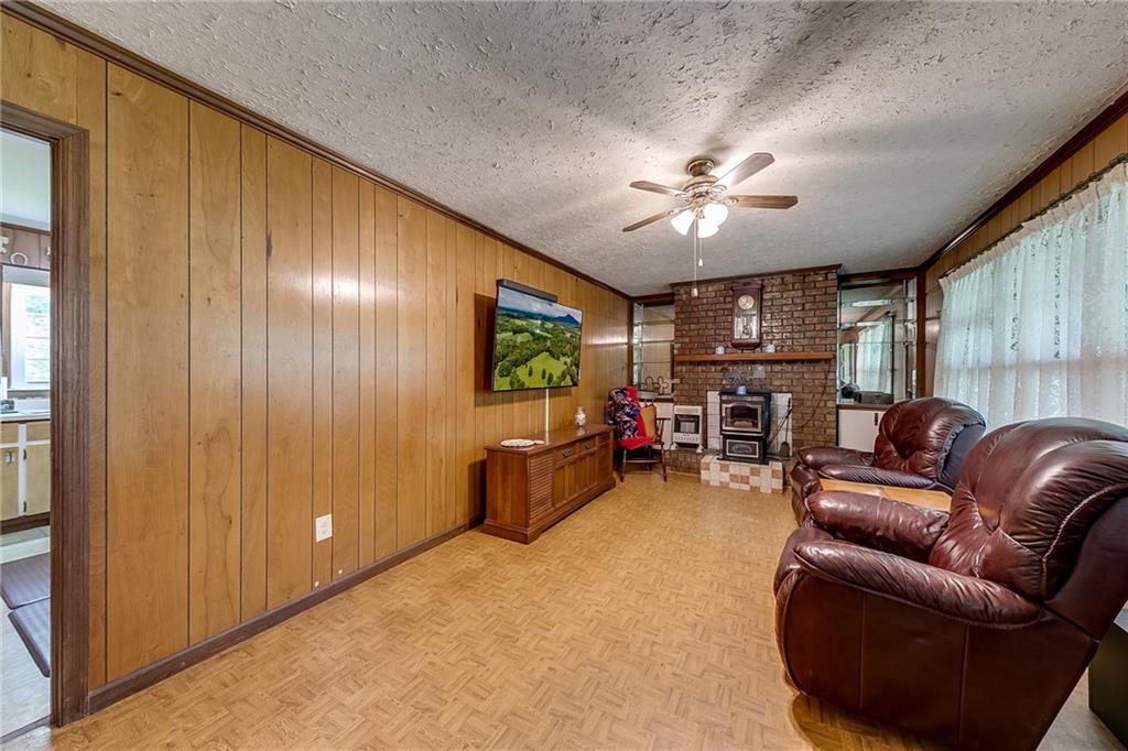6223 Hulsey Road Clermont, GA 30527 - Photo 14 of 53 a living room with furniture and a flat screen tv