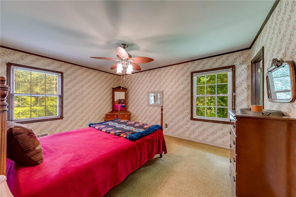 6223 Hulsey Road Clermont, GA 30527 - Photo 21 of 53 a bedroom with a bed and a chandelier