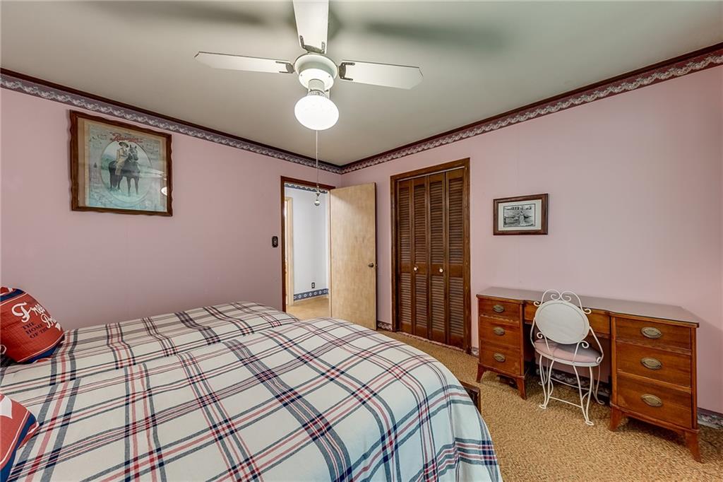 6223 Hulsey Road Clermont, GA 30527 - Photo 24 of 53 a bedroom with a bed and a chandelier